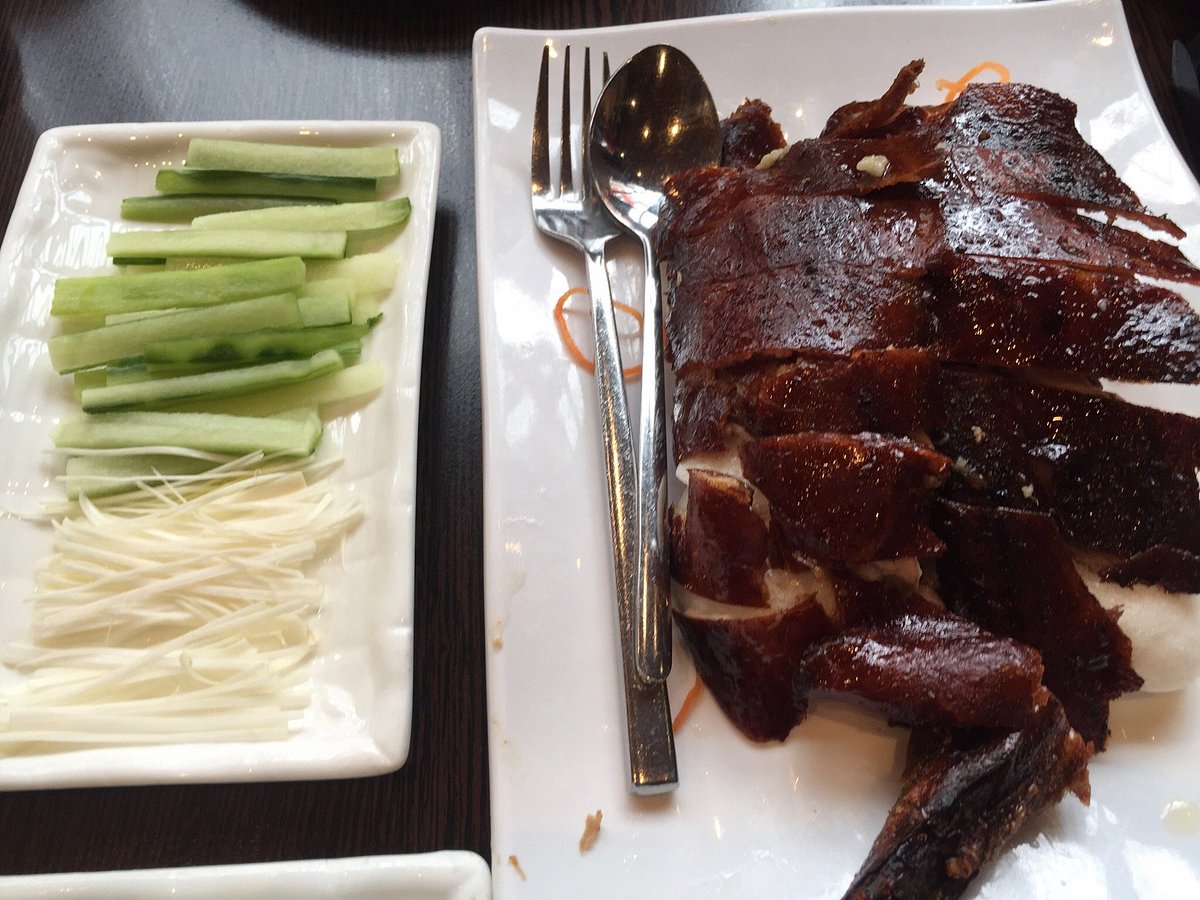 Roast duck served with cucumber and spring onion